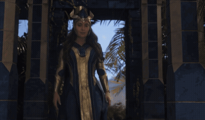 Woman In Blue And Gold Costume By Building GIF
