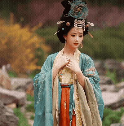 Woman In Blue And Gold Dress With Flower On Head GIF