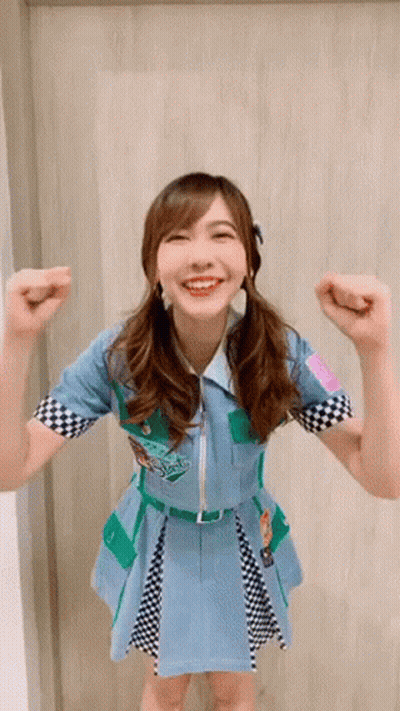 Woman In Blue And Green Dress Smiling GIF