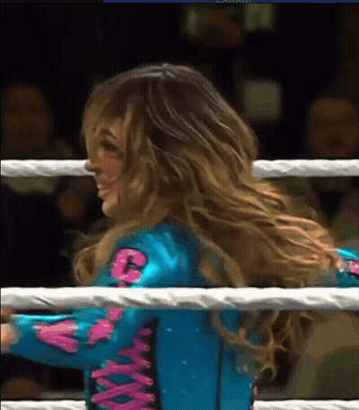 Woman In Blue And Pink Outfit With Letter C In Boxing Ring GIF