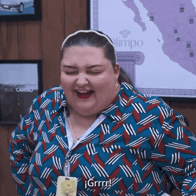 Woman In Blue And Red Shirt Laughing With Eyes Closed In Front Of Map GIF