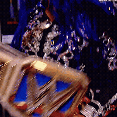 Woman In Blue And Silver Dress Holding Gold Crown GIF