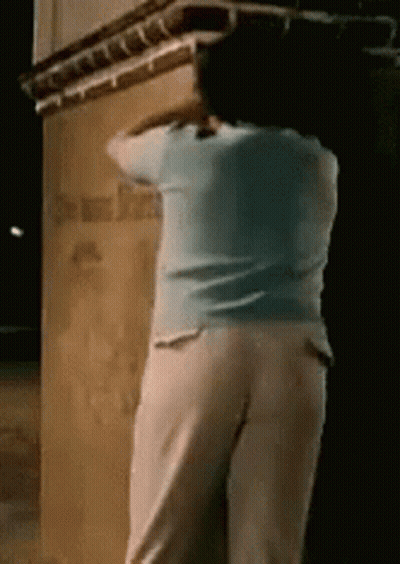 Woman In Blue And White By Building Night GIF