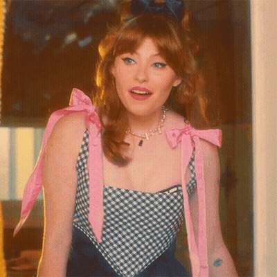 Woman In Blue And White Checkered Top With Pink Bow GIF
