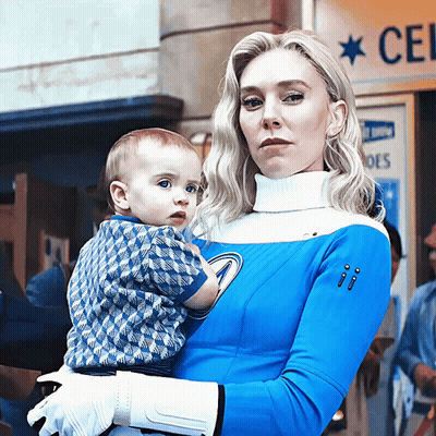 Woman In Blue And White Costume Holding Baby GIF