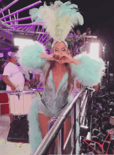 Woman In Blue And White Feathered Costume On Stage GIF