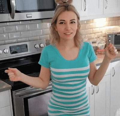 Woman In Blue And White Striped Shirt By Microwave GIF
