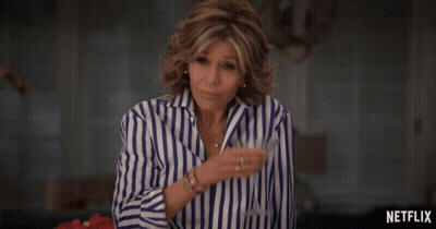 Woman In Blue And White Striped Shirt By Netflix Sign GIF
