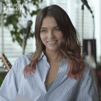 Woman In Blue And White Striped Shirt Smiling At Microphone GIF