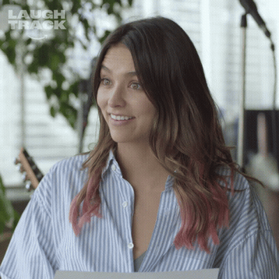Woman In Blue And White Striped Shirt Smiling In Front Of Laugh Track Logo GIF