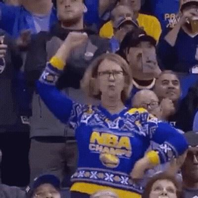 Woman In Blue And Yellow Sweater Cheering At Basketball Game GIF