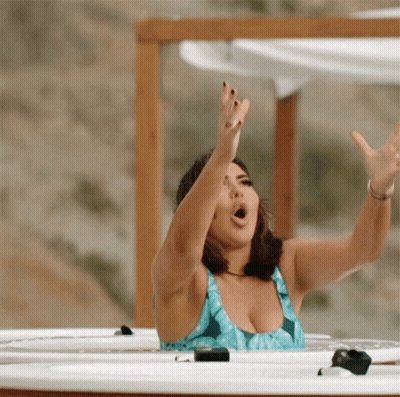 Woman In Blue Bathing Suit Hot Tub Arms Outstretched GIF