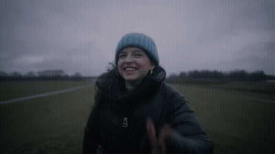 Woman In Blue Beanie And Black Jacket With Letter A GIF