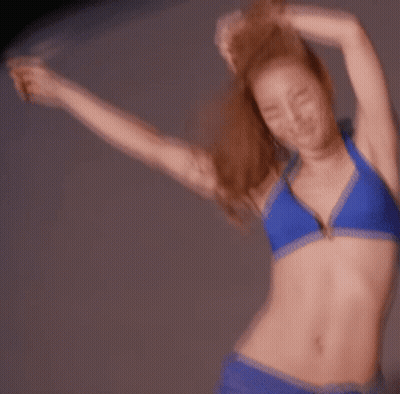 Woman In Blue Bikini Dancing With Arms Outstretched GIF