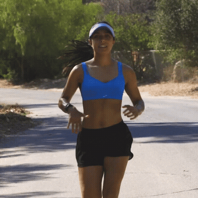 Woman In Blue Bra And Black Shorts Running On Road GIF