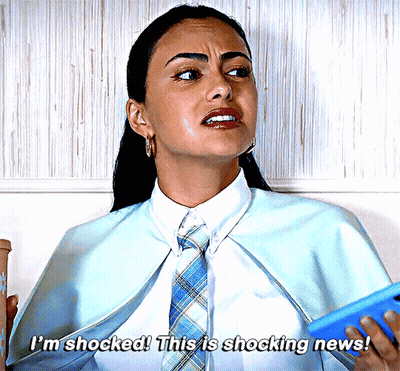 Woman In Blue Cape And Tie Says Shocked GIF