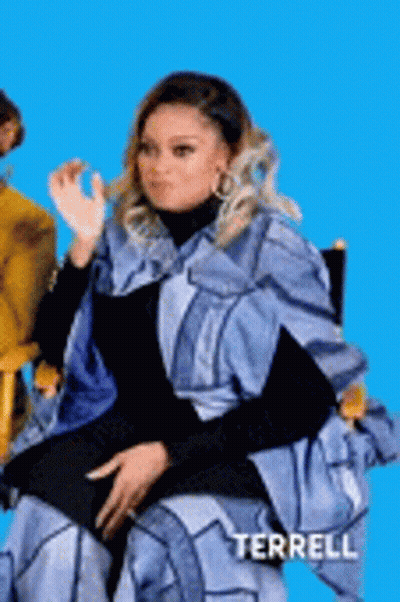 Woman In Blue Cape Making Funny Face GIF