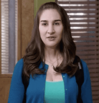 Woman In Blue Cardigan And Blue Shirt GIF