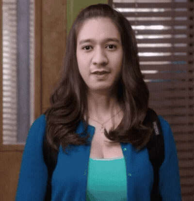 Woman In Blue Cardigan And Green Tank Top GIF