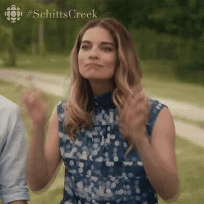 Woman In Blue Clapping Schitt's Creek Logo GIF
