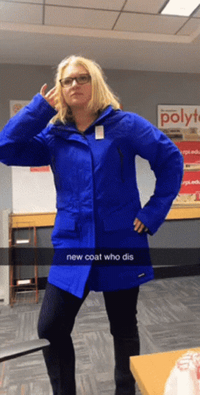 Woman In Blue Coat In Front Of Poly Sign GIF