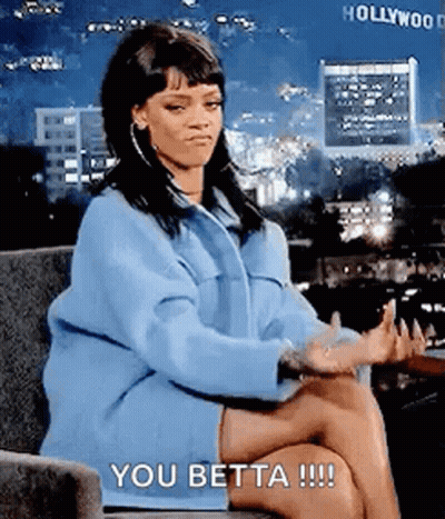 Woman In Blue Coat Sitting Cross-Legged Saying You Betta GIF