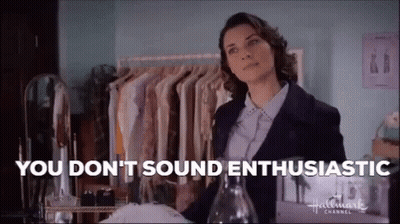 Woman In Blue Coat Sitting In Front Of Hollywood Sign GIF