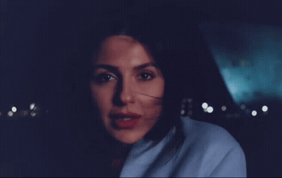 Woman In Blue Coat Smiling At Camera GIF