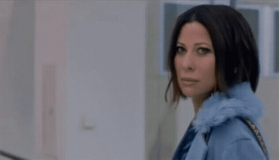 Woman In Blue Coat Walking With Purse GIF