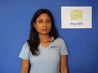 Woman In Blue 'Deaf' Shirt Facing 'Month' Calendar GIF