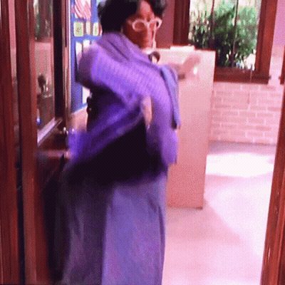 Woman In Blue Dress And Glasses At Window GIF