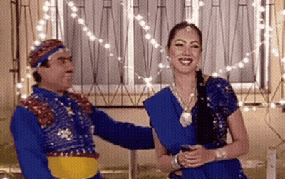 Woman In Blue Dress And Man By Window GIF