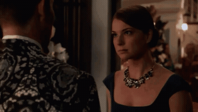 Woman In Blue Dress And Necklace Looking At Man GIF