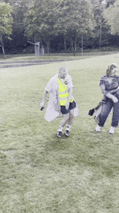 Woman In Blue Dress And White Jacket Walking Down Street GIF