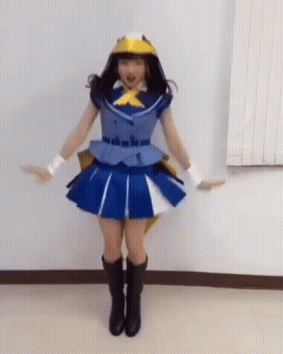 Woman In Blue Dress And Yellow Hat With Arms Outstretched GIF