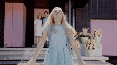Woman In Blue Dress At Pink Building Number 6 GIF