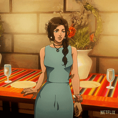 Woman In Blue Dress At Table With Netflix Logo GIF