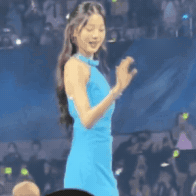 Woman In Blue Dress Clapping Before Crowd GIF