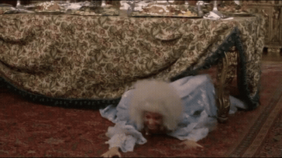 Woman In Blue Dress Crawling Under Table GIF