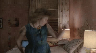 Woman In Blue Dress Dancing In Bedroom GIF