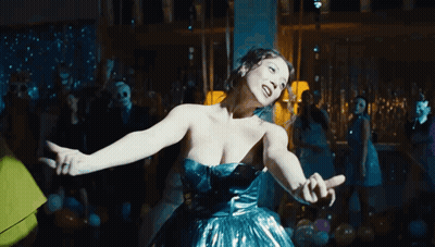 Woman In Blue Dress Dancing In Crowded Room GIF