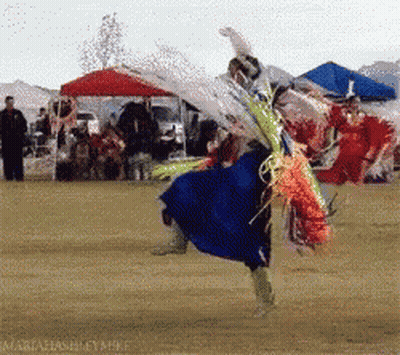 Woman In Blue Dress Dancing In Field GIF