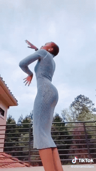 Woman In Blue Dress Dancing On Balcony TikTok GIF