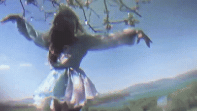 Woman In Blue Dress Dancing Under Tree GIF