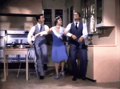 Woman In Blue Dress Dancing With Two Men In Suits GIF