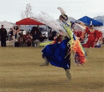 Woman in Blue Dress Dancing With Word Maria Behind Her