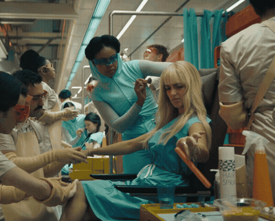 Woman In Blue Dress Getting Hair Styled GIF