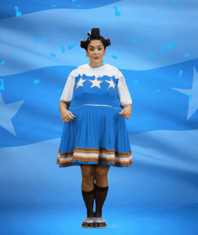 Woman In Blue Dress Holding Banner Saying Felices Fies GIF