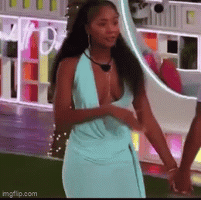Woman In Blue Dress Holding Man's Hand At Mirror GIF