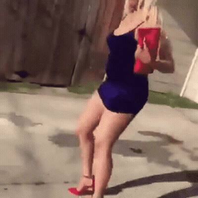 Woman In Blue Dress Holding Red Purse GIF